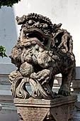 Bangkok Wat Pho, detail of the chinese Guardian Lion of the entrance doorway of the double ringed cloister around the ubosot. 